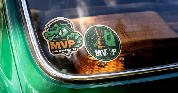 Greenlight Guru event stickers on a car window